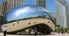 Tourists visit "Cloud Gate", a sculpture by Anish Kapoor, in Millenium Park in Chicago, Illinois.