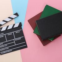 For a quiz about books/film adaptations. Clapper board and books or scripts. cinema, movies, motion pictures, clapboard, hollywood